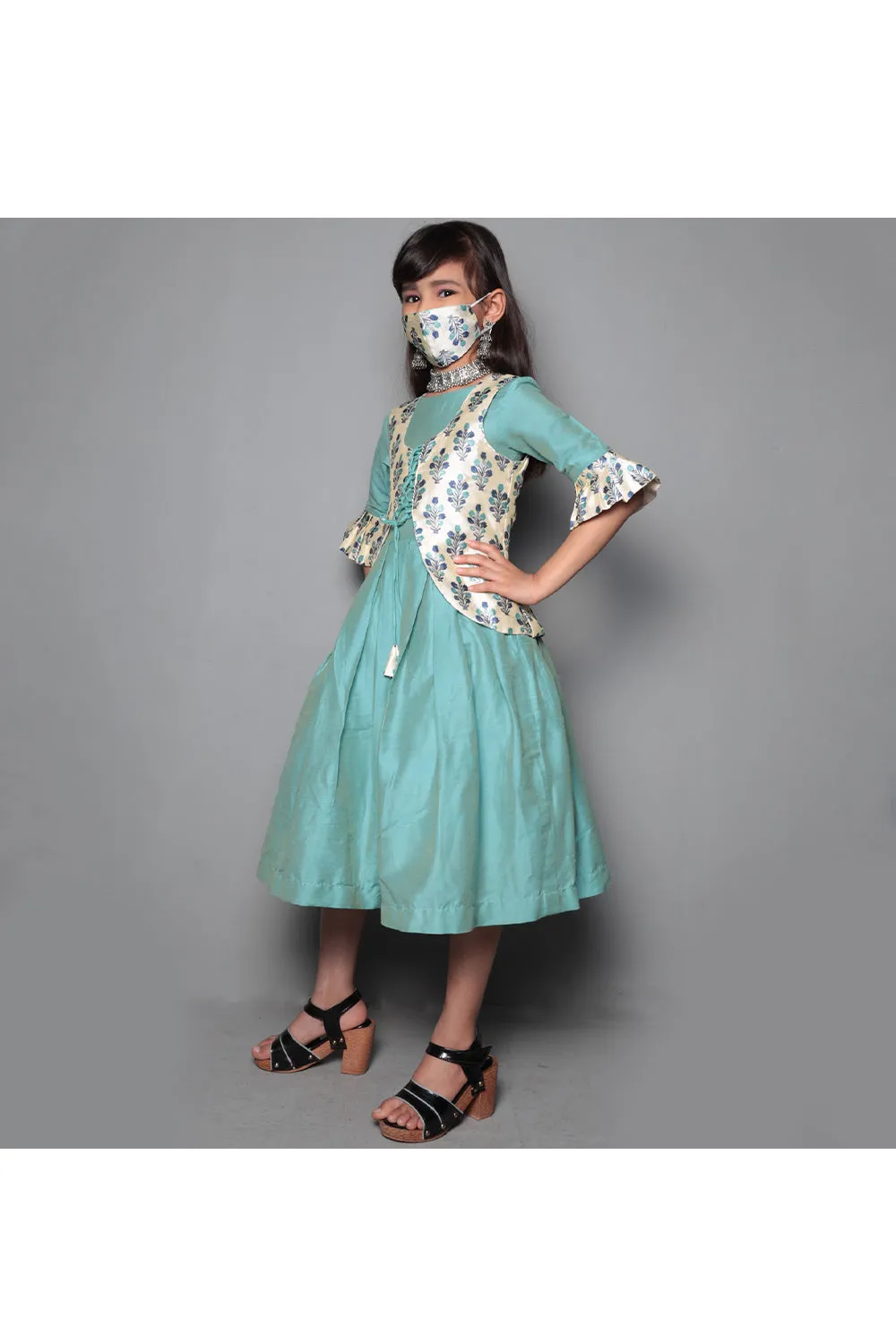 Pastel green dress with grey floral printed jacket and mask